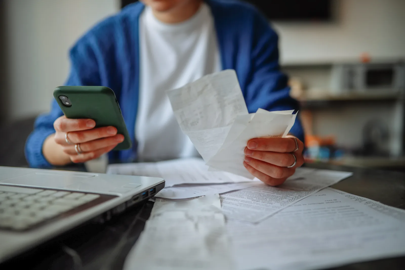 Utilizator verificând bonuri fiscale pe telefonul mobil.