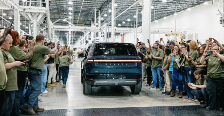 Angajați Rivian sărbătoresc producția noului model R2 în fabrică.