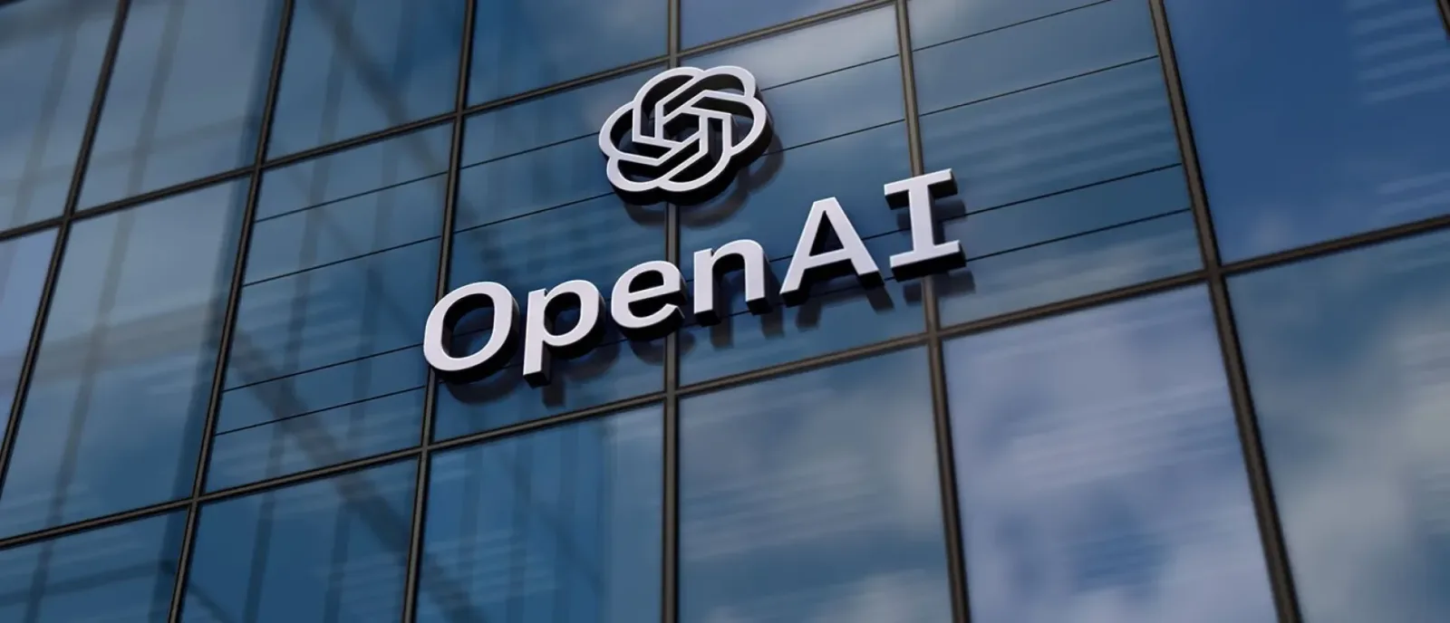 Logo-ul OpenAI pe o clădire modernă cu feronerie din sticlă.