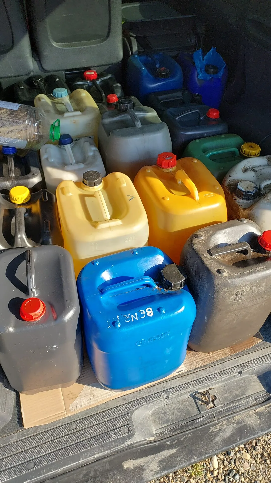 Canistre de motorină adunate într-un vehicul, evidențiind furtul de pe șantier.