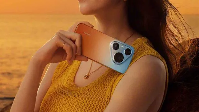 Un telefon Huawei cu un design gradient atractiv, surprins în lumina apusului.