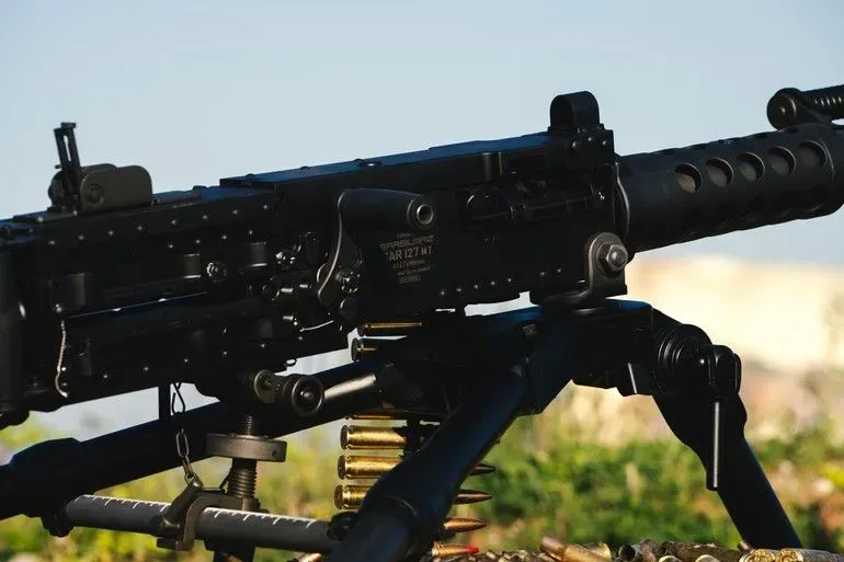 Pușcă de asalt pe un suport, pregătită pentru utilizare în exerciții militare.