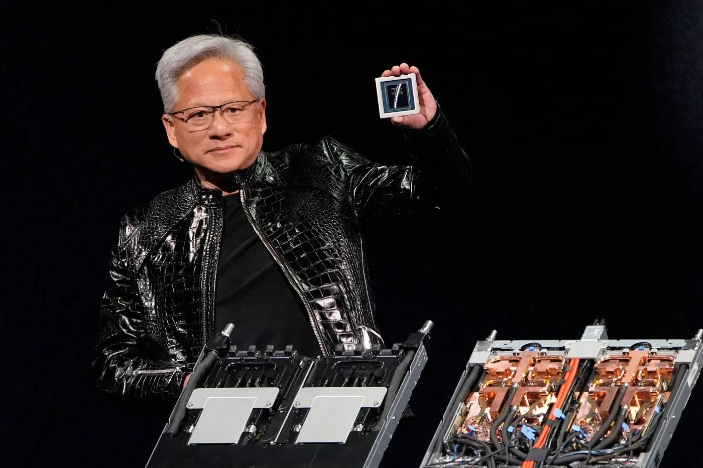Jensen Huang prezentând un cip Nvidia pe scenă.