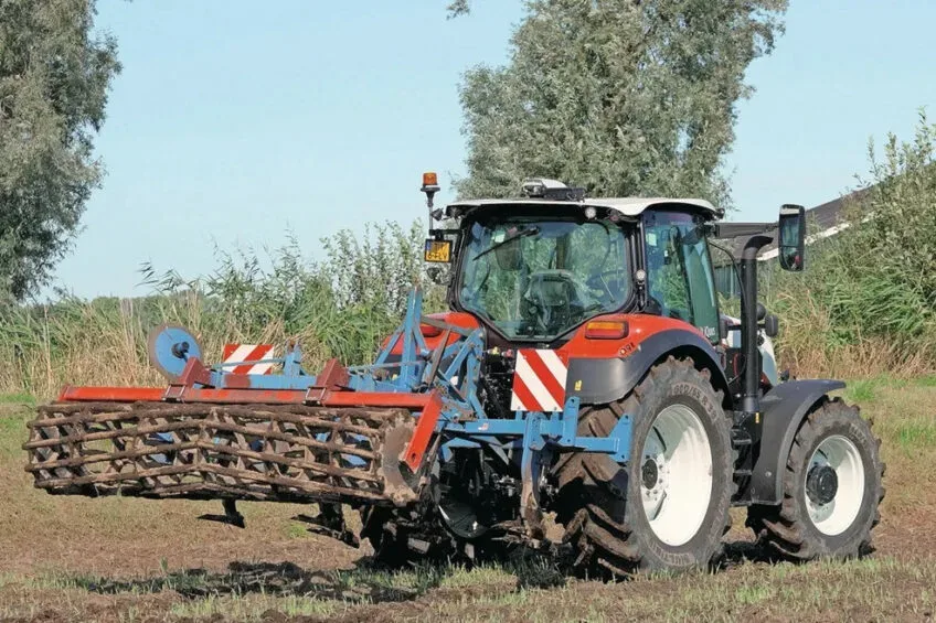 Tractor pe câmp, pregătind terenul pentru cultivare.
