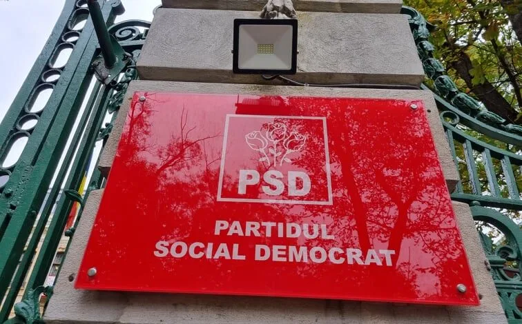 Sigla Partidului Social Democrat pe un fundal roșu vibrant.