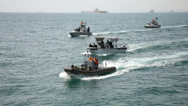 Nave militare iraniene navigând în Strâmtoarea Ormuz, marcând un coridor sigur.