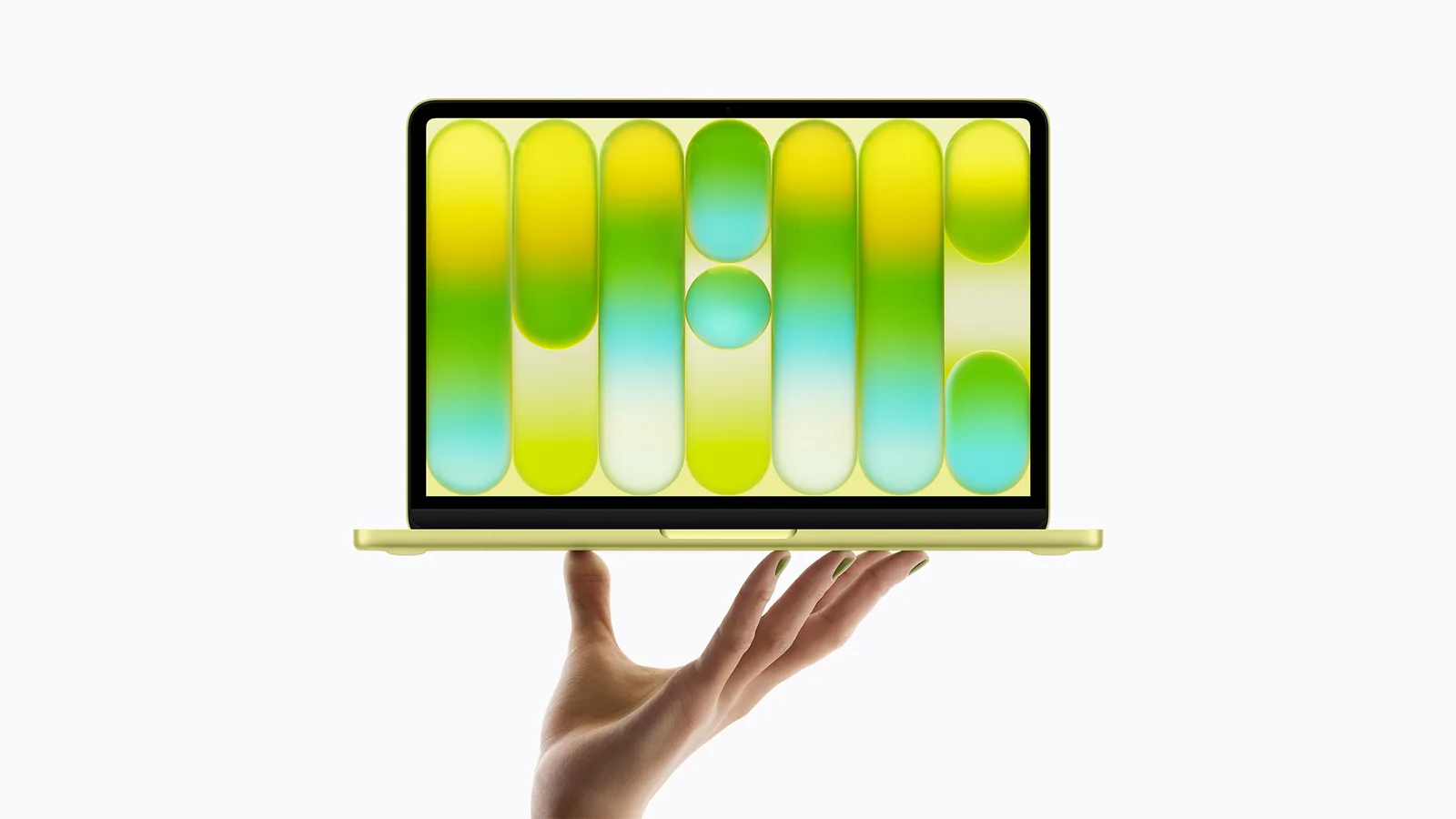 Laptop Apple cu un design modern și culori vibrante, ținut în mână.