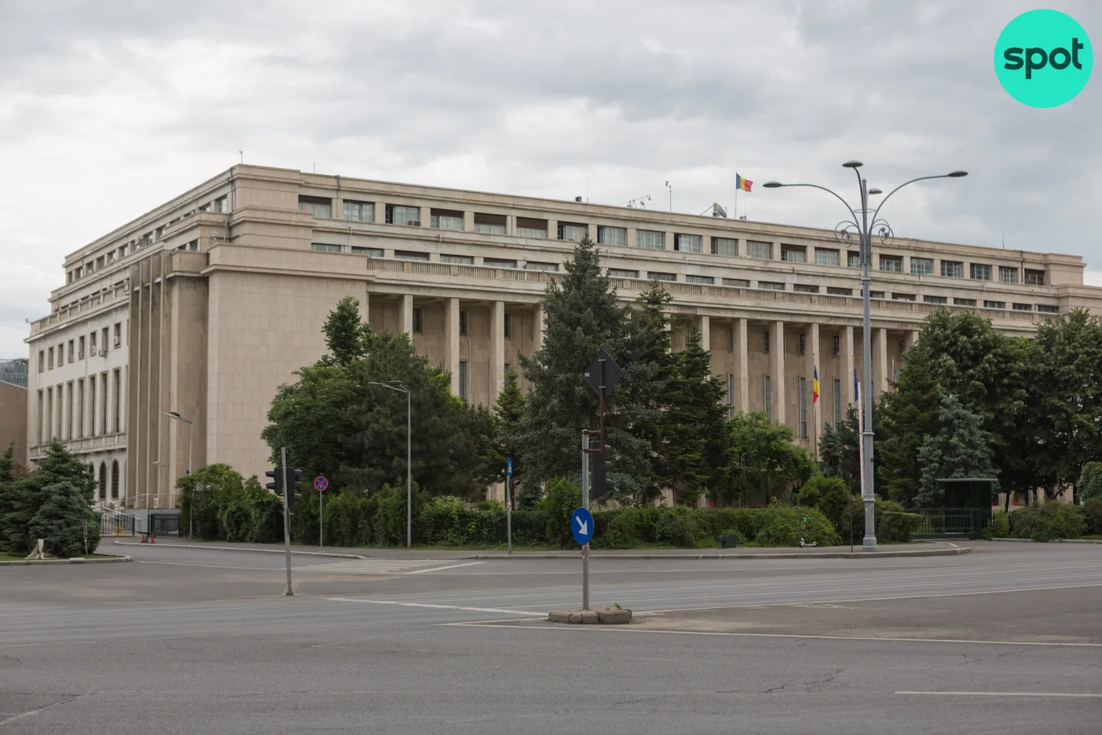 Clădirea guvernului României înconjurată de copaci și străzi.