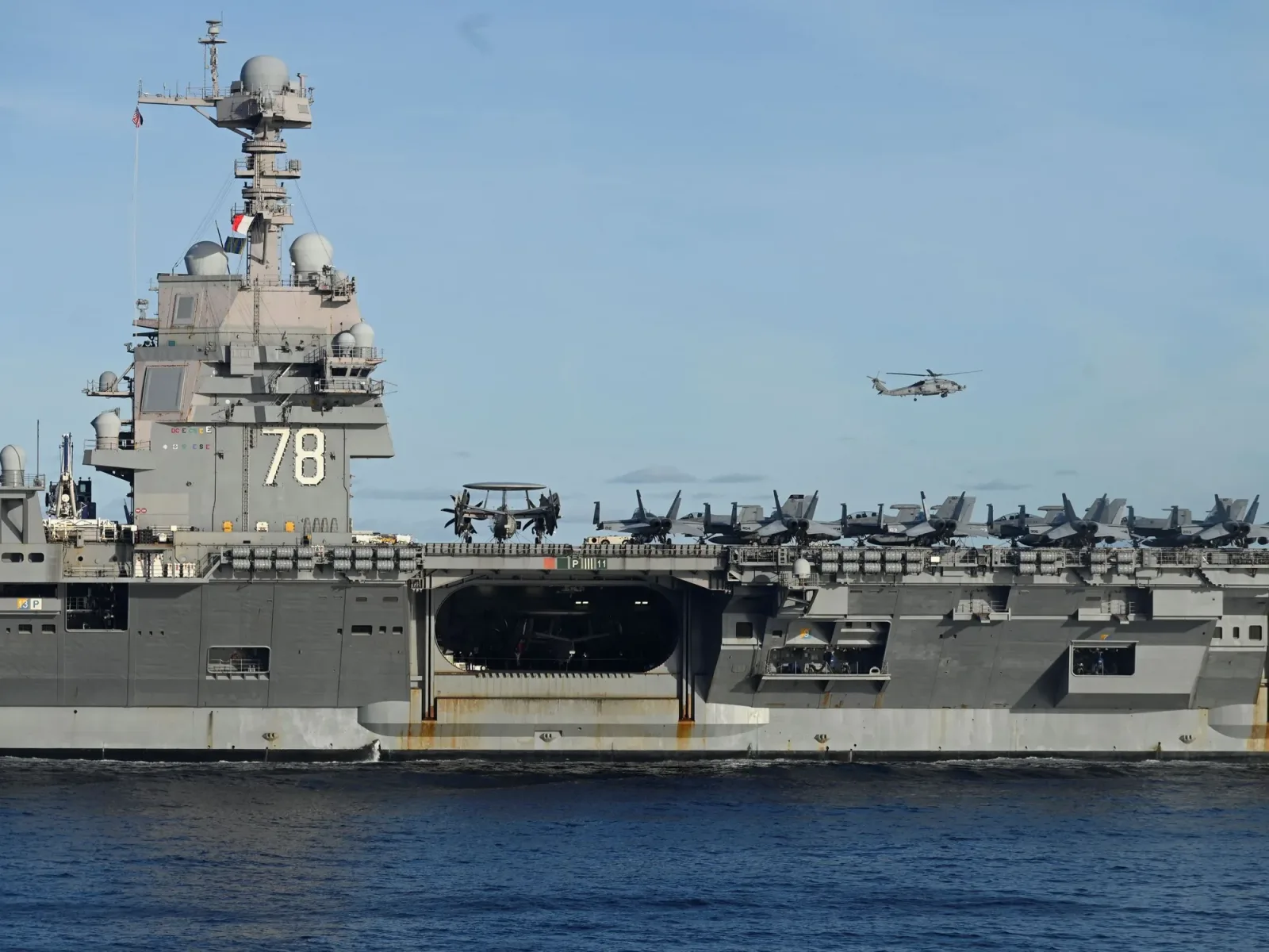 Portavion american cu elicoptere în acțiune pe mare.