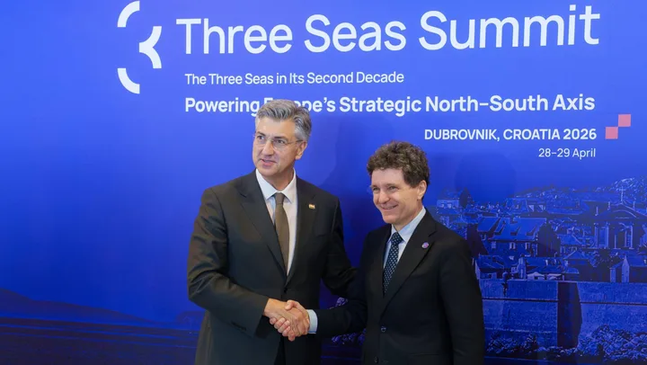 Nicușor Dan și un oficial la Summitul Inițiativei celor Trei Mări, strângere de mâini.