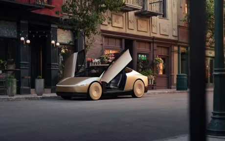 Cybercab Tesla, mașină electrică eficientă, cu uși deschise pe stradă.
