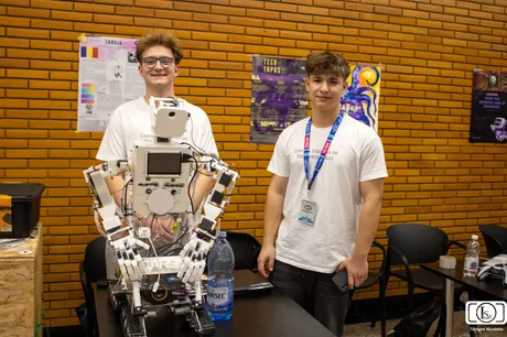 Studenți prezintă un robot autonom la competiția RoboChallenge din București.