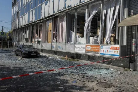 Clădire avariată de atacuri, sticlă spartă și distrugeri vizibile.