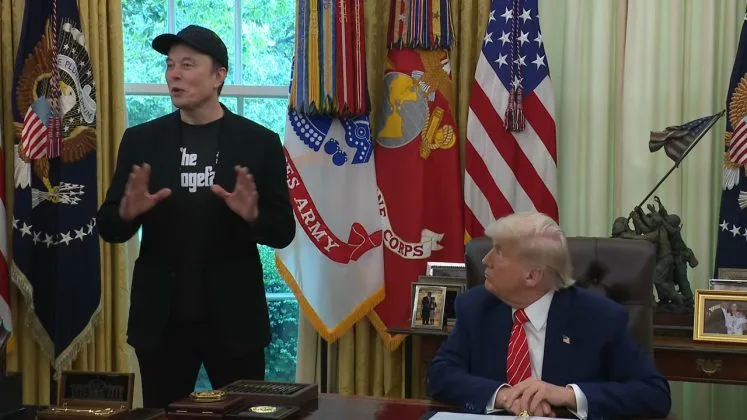 Donald Trump și Elon Musk discutând despre afaceri în biroul oval.