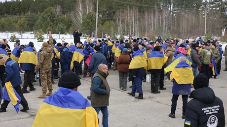 Oameni adunați pentru a sărbători un schimb de prizonieri în Ucraina.