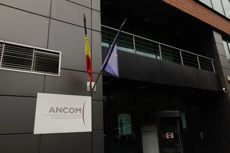 Sediul ANCOM cu steagurile României și Uniunii Europene expuse.