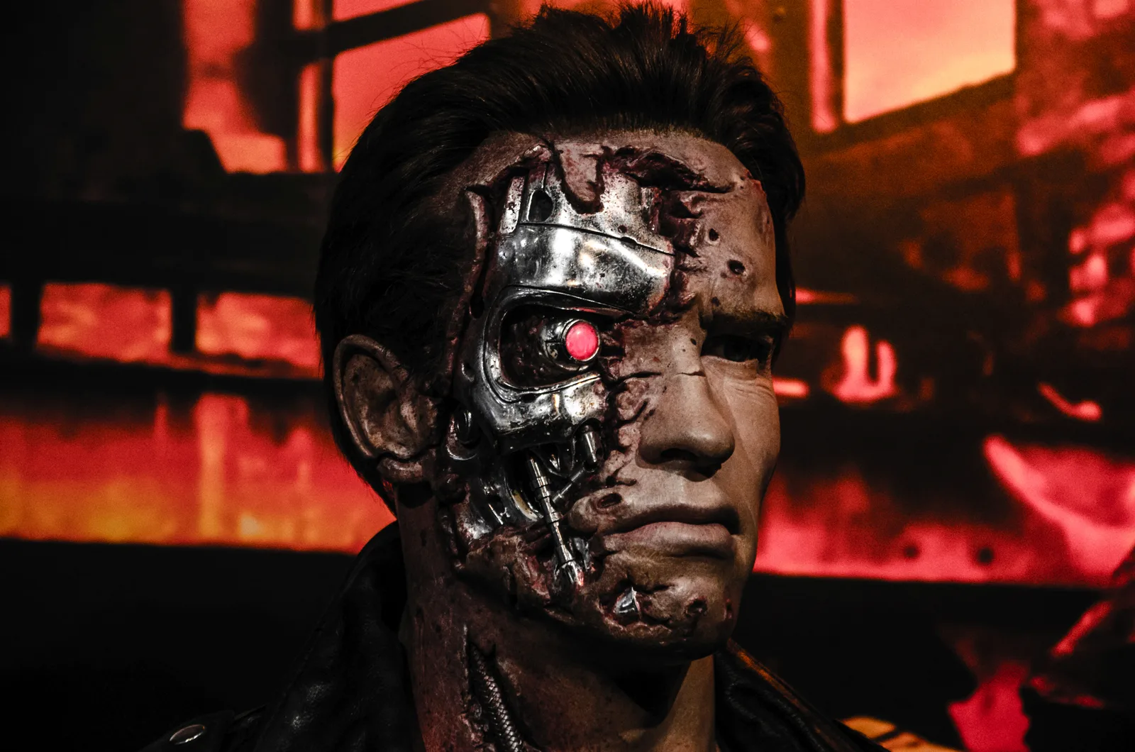 Un robot cu trăsături umane, având un ochi roșu și detalii metalice, evocând teme apocaliptice.