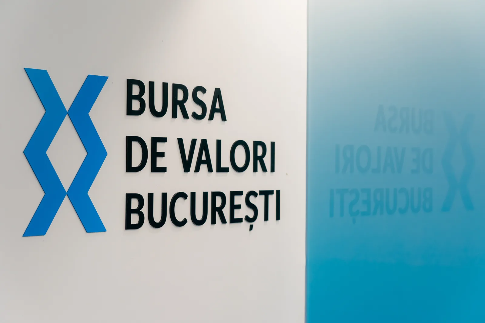 Logo-ul Bursei de Valori București pe un fundal alb și albastru.