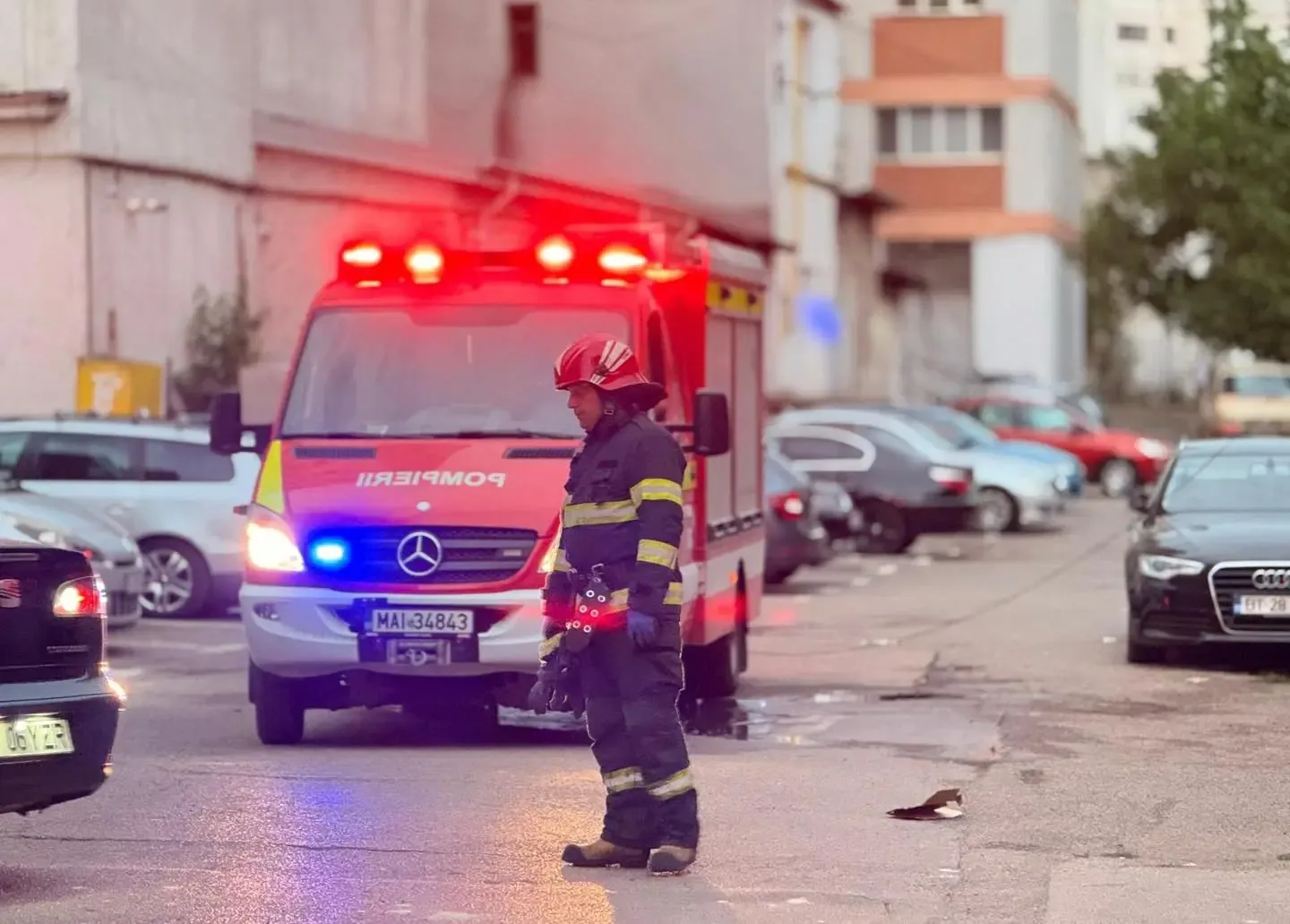 Pompier intervenind la un incendiu în Sectorul 5, cu degajări de fum vizibile.
