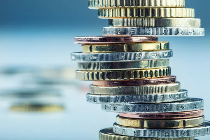 Monede aranjate pe un fundal alb, simbolizând investiții și finanțări.