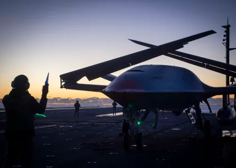 Dronă MQ-25A Stingray pregătită pentru realimentare pe portavion la apus.