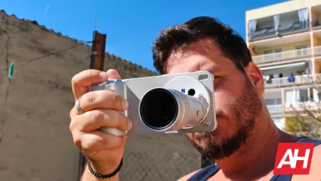 Un bărbat fotografiind cu un smartphone într-un mediu urban.