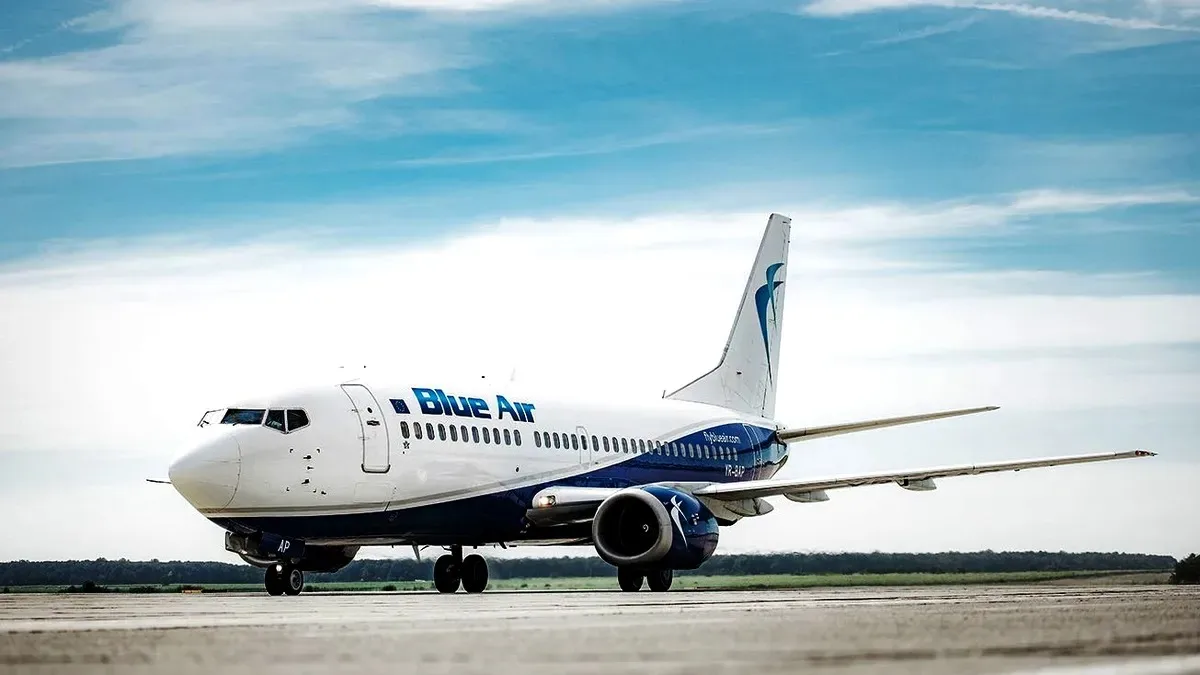 Aeronava Blue Air pe pista de decolare, sub un cer senin.