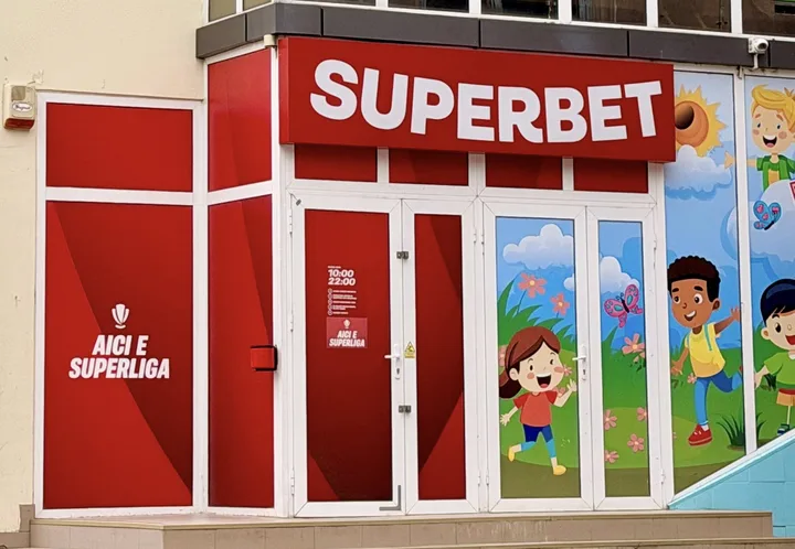 Clădire cu reclame pentru jocuri de noroc și copii jucându-se în față.