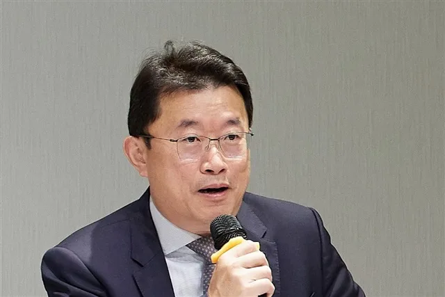 Un bărbat vorbește la microfon despre creșterea prețurilor la electronice.