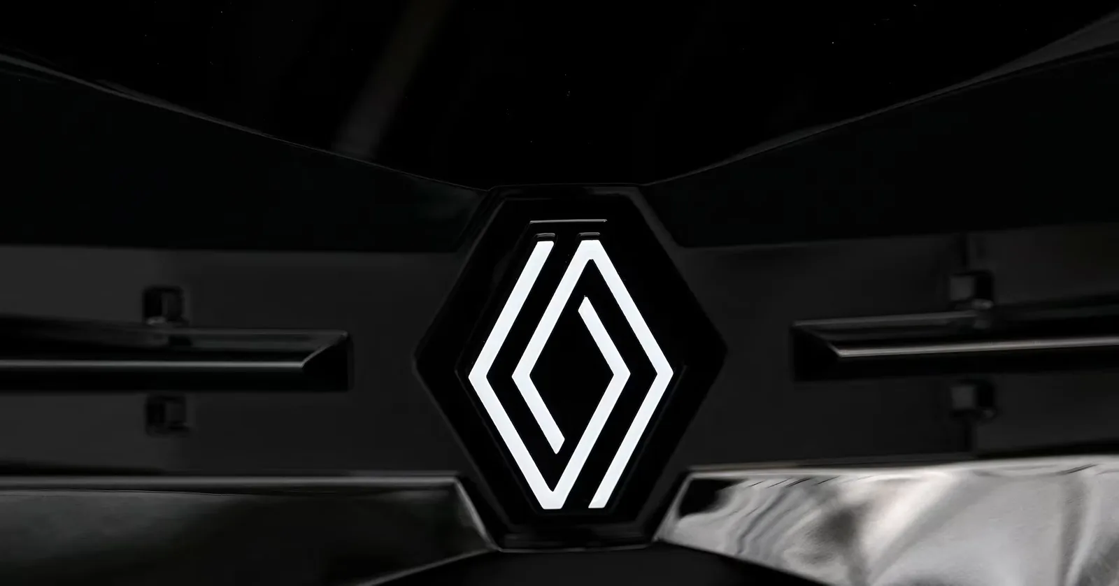Logo-ul Renault pe fundal întunecat, simbolizând inovația și schimbarea.
