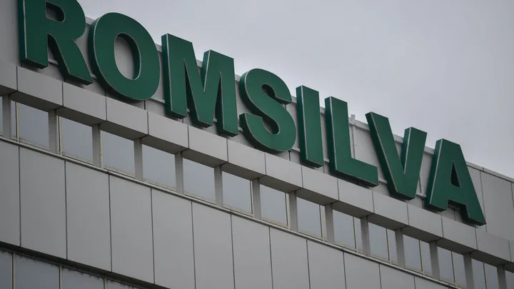 Clădirea Romsilva cu sigla verde pe fațadă, sub un cer noros.