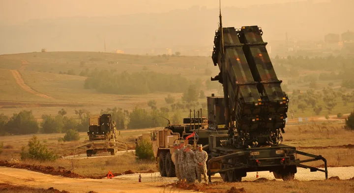 Soldați americani pregătesc echipamente militare în peisajul arid.