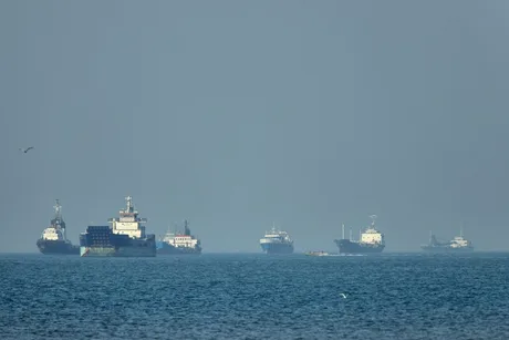 Nave comerciale navigând în Strâmtoarea Ormuz, într-un context de tensiuni militare.