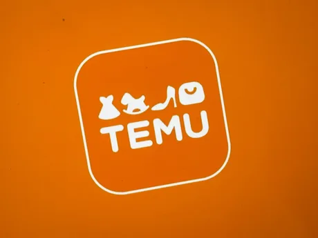 Logo Temu pe fundal portocaliu, simbolizând comerțul online.